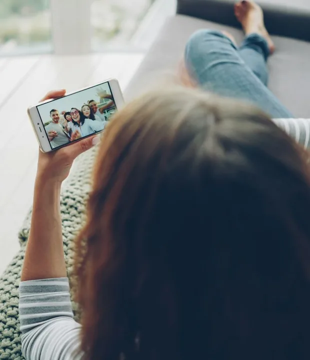 A phone held up showing a video call in progress