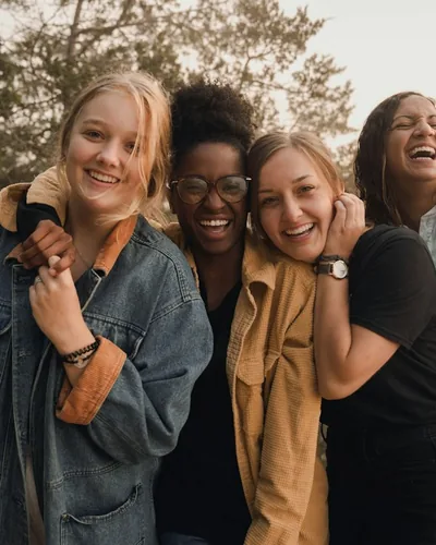 Four friends laughing together